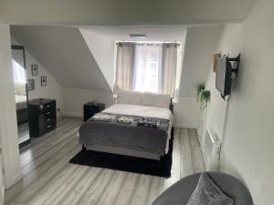 a small bedroom with a bed and a window at Studio Flat in Largs