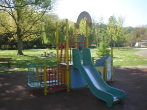 a playground with a slide in a park at Camping Au Coeur de Vendome in Vendôme