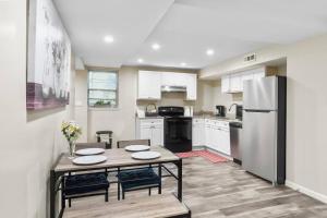 a kitchen with a table and a refrigerator at Elegant 1-BR Apartment in Silver Spring