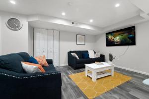 a living room with a couch and a table at Elegant 1-BR Apartment in Silver Spring