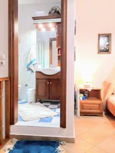 a bathroom with a sink and a mirror at La Casa Di Silvia in Apolakkiá