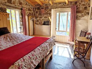 a bedroom with a bed in a room with stone walls at Stazzu la Capretta Farm Camping & Guest Rooms in Olbia