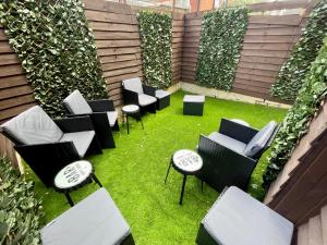 an outdoor seating area with chairs and grass at 4 Bedroom Anfield House, 7 beds, Free Parking, Garden - 5 mins to LFC, 15 mins to City Centre in Liverpool