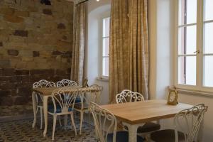a dining room with tables and chairs and a brick wall at Boutique-Hotel im Sternenhof in Großkarlbach