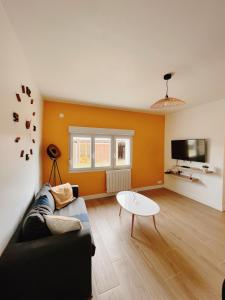 a living room with a couch and a table at Happy House in Torcenay