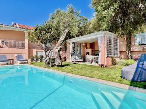 a swimming pool in front of a house at Villa Evmaria with private swimming pool in Spartýlas