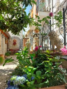 a garden with flowers in front of a building at Giardino Del Sole in Taormina
