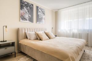 a bedroom with a large bed and a window at The World is Yours seaside apartment in Liepāja