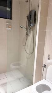 a shower in a bathroom with a toilet at S1 Cozy Home Sunway Geo 2Queens Sunway Medical Centre in Petaling Jaya