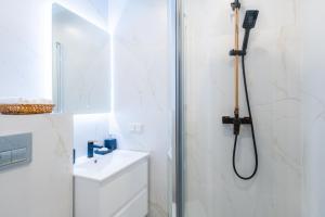 a bathroom with a shower and a toilet and a sink at The World is Yours seaside apartment in Liepāja