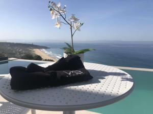a table with a vase with a flower on it at Villa El Buzo in Zahara de los Atunes