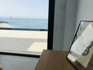 a room with a window with a view of the ocean at Villa El Buzo in Zahara de los Atunes