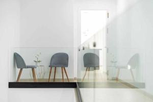 a room with two chairs and a glass table at Villa El Buzo in Zahara de los Atunes