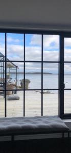 a room with a view of a beach through a window at Hideaway Engvej in Guldborg