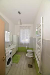 a bathroom with a toilet and a sink at Casa vacanze il Pastore Tedesco in Portoferraio