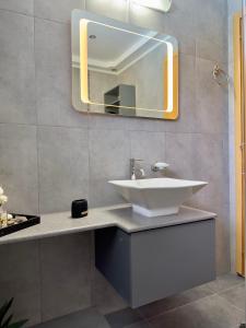 a bathroom with a sink and a mirror at Villa Rose Ground Floor - Private Swimming Pool Garden in Koskinou