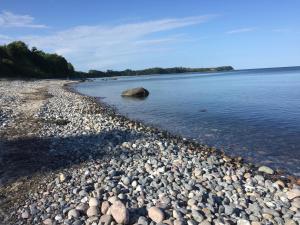 a large group of rocks on a beach in the water at Meerzauber in Altenkirchen