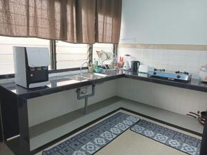 a small kitchen with a sink and a counter top at RIANI HOMESTAY in Kertih