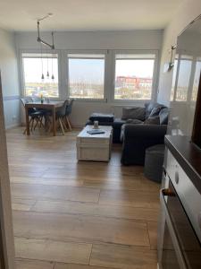 a living room with a couch and a table at derankerplatz-fehmarn in Burgtiefe auf Fehmarn  +23 photos