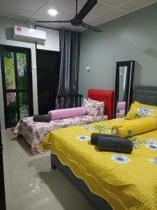 two beds sitting next to each other in a room at RIANI HOMESTAY in Kertih