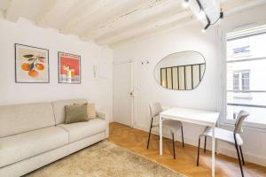 a living room with a couch and a table at GuestReady - Wabi-Sabi Minimal in Marais in Paris