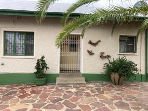 a house with a gate on the side of it at Ramblers Self Catering Accommodation in Windhoek