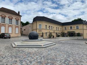 a large building with a black ball in front of it at L'étape Champenoise in Ay