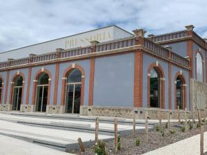 a brick building with a sign on the side of it at L'étape Champenoise in Ay