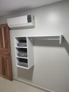 a bathroom with a towel rack with towels at JR Casa Contêiners in Boa Vista