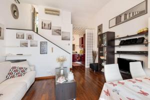 a living room with a white couch and a fireplace at Al 37 vista mare e colline in Finale Ligure