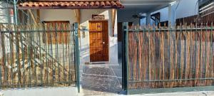 a house with a gate and a wooden door at Elizas house in Nea Makri