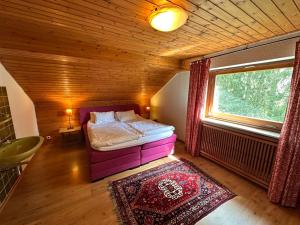 a small bedroom with a bed and a window at Private Spacious Villa near Winterberg and Willingen 14 Guests HUGE GARDEN Free Parking for Multiple Cars in Olsberg