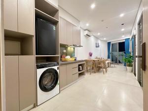 a kitchen with a washer and dryer in a room at The Song Yuki Apartment in Vung Tau