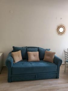 a blue couch with two pillows in a living room at Budva Gate in Budva