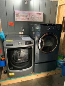 a washing machine and a microwave on a shelf at Beach Breeze 3, pet friendly, walking distance to Atlantic Ocean free parking in Myrtle Beach
