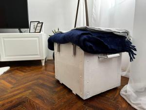 a wooden box with a blue blanket on top of it at Pure of joy City Centre Apartment in Subotica +24 photos