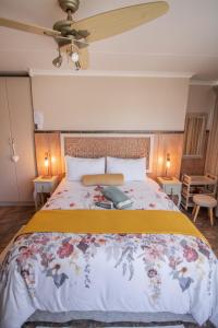 a bedroom with a large bed with a yellow blanket at SUMMER PLACE in Harrismith