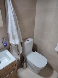 a bathroom with a white toilet and a sink at Perseids Traditional House in Amorgos +14 photos