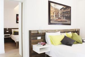 a bedroom with a white bed with yellow pillows at Agriturismo Canova in Negrar