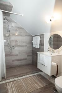 a bathroom with a shower and a toilet and a sink at EcoSilini 