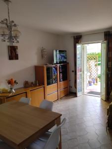 a dining room with a table and chairs and a sliding glass door at Villa Lucia in Sabaudia