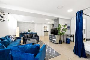 a living room with blue couches and a tv at Sirena Apartment - Self check-in and free parking in Tallinn