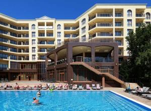 a swimming pool in front of a large building at Romance Apartment Golden Line for Rent in Golden Sands
