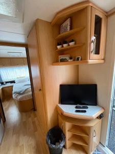 a small kitchen in a tiny house with a stove at Cozy Caravan in Vestmannaeyjar