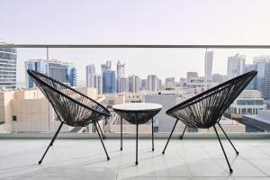 two chairs and a table in front of a window at 5* Studio, 10min walk to Dubai Mall, 1min Bay Sqr in Dubai
