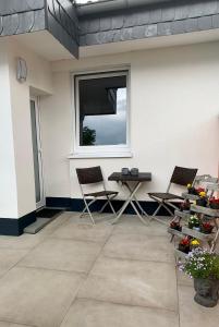 een patio met stoelen, een tafel en een raam bij Apartments WK in Keulen