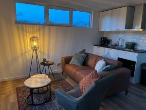 sala de estar con sofá y mesa en Linked Chalet, en Oostvoorne