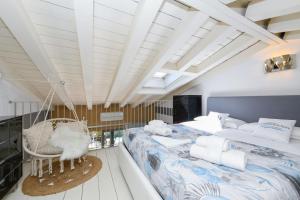 a bedroom with a large bed and a swing at Acquarius Resort Sirmione - MGH in Sirmione