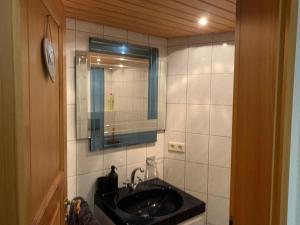 a bathroom with a sink and a mirror at KM Apparts 2 Wesel in Wesel +11 photos