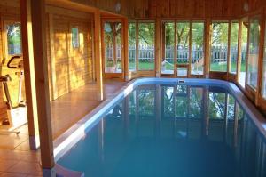 a house with a pool in the middle of a house at Kisecset-vendégház in Kisecset